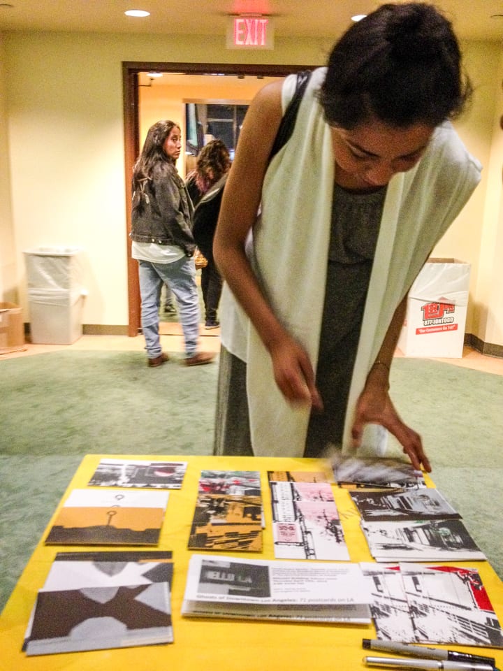 Participants writing on postcards