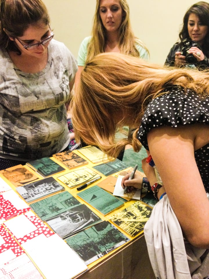 Participants writing on postcards