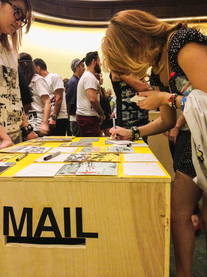 Participants writing on postcards