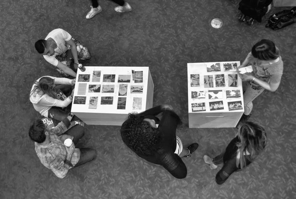 Participants writing on postcards