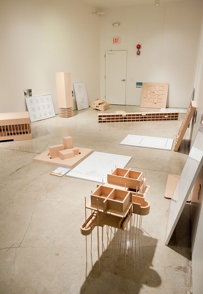 People looking at architectural models in gallery