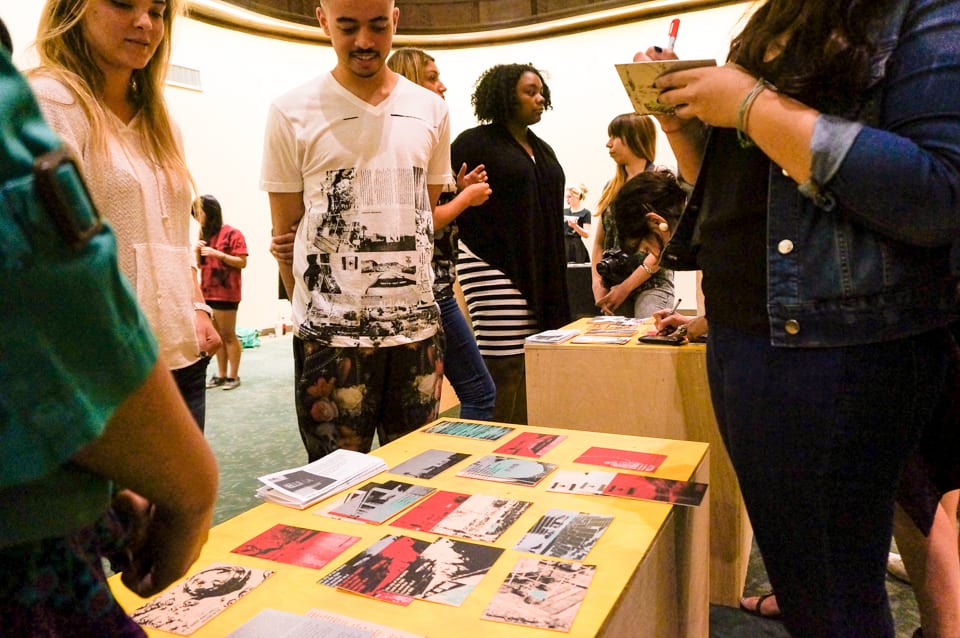 Participants writing on postcards