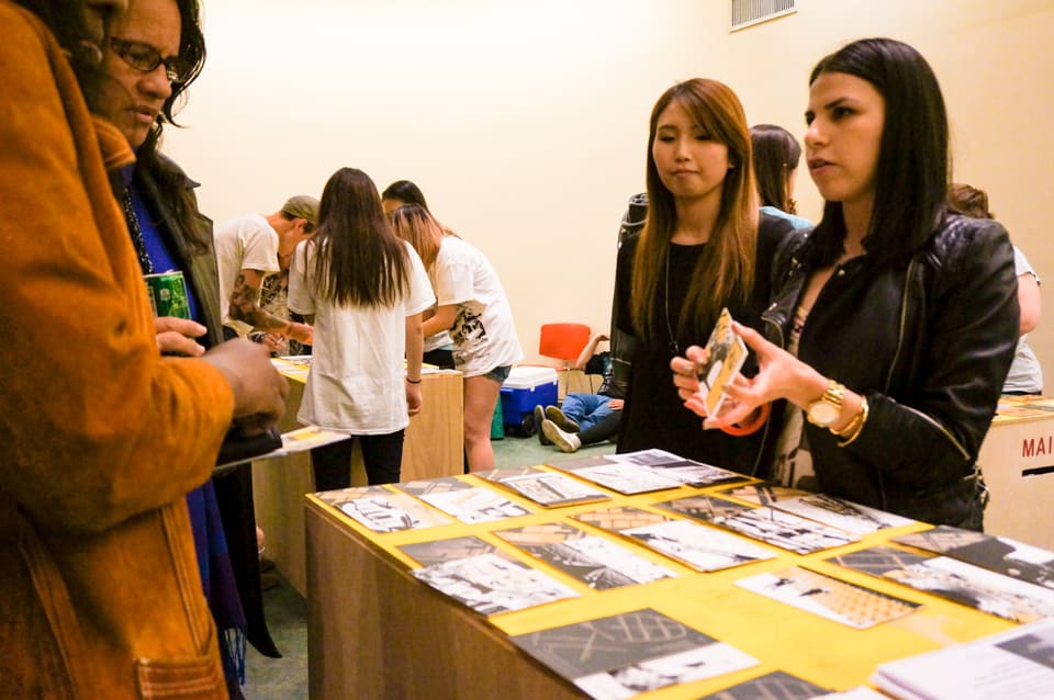 Participants writing on postcards