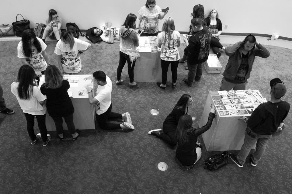 Participants writing on postcards