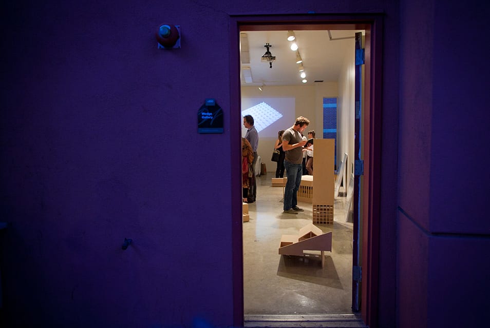 People looking at architectural models in gallery