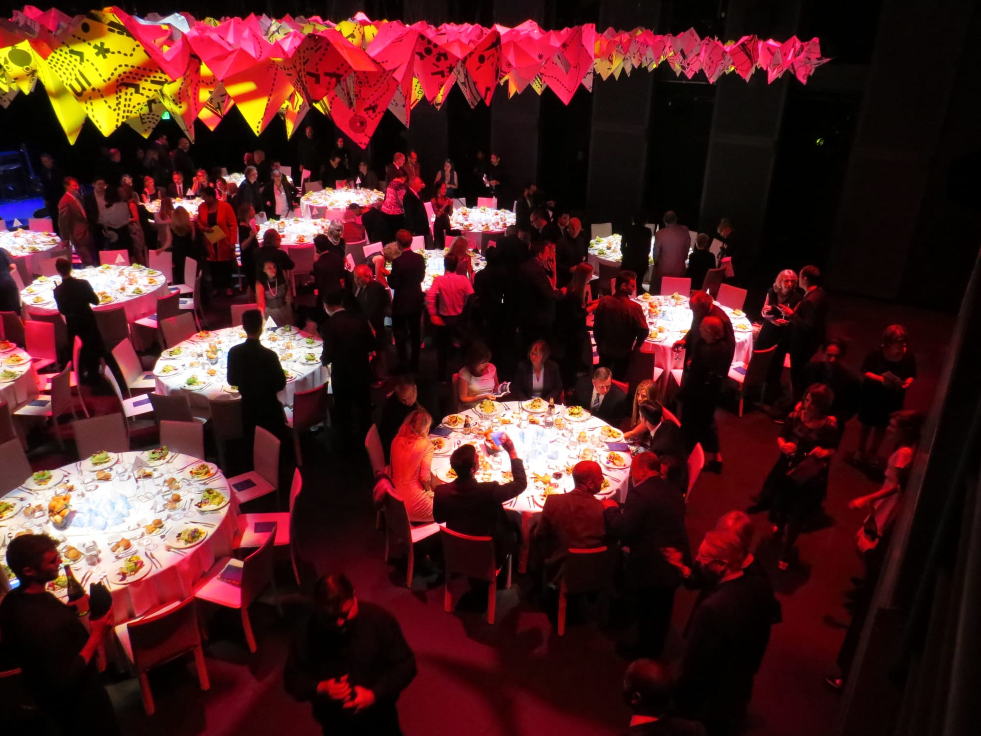 People sitting at round tables at a party