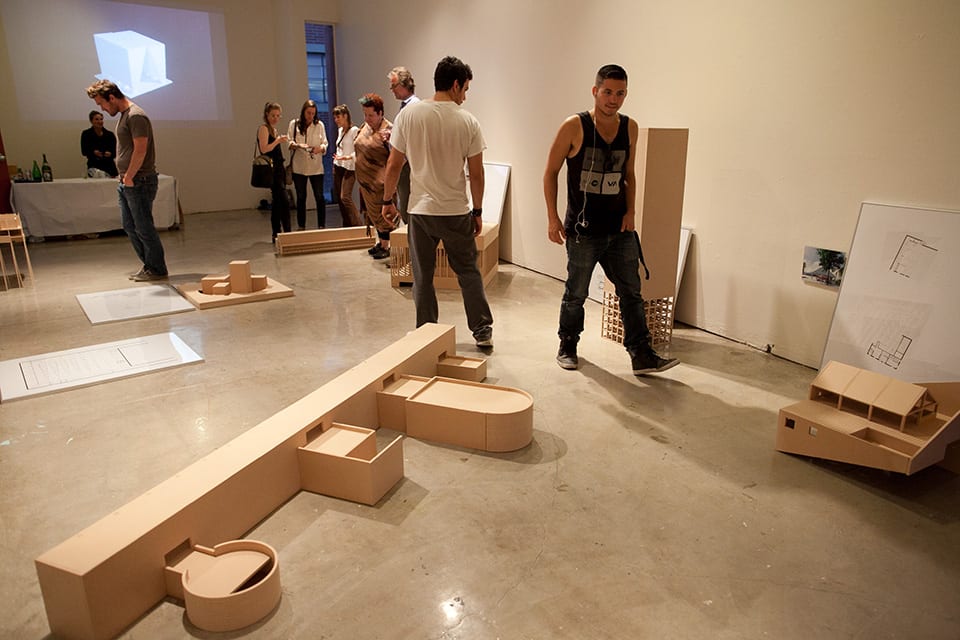 People looking at architectural models in gallery