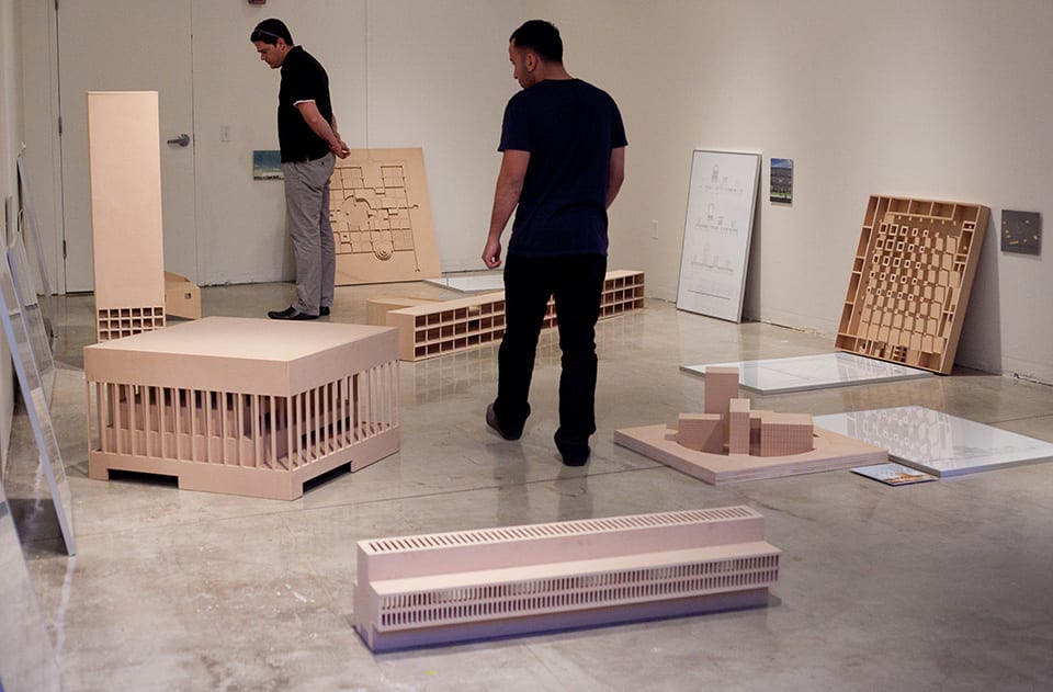 People looking at architectural models in gallery