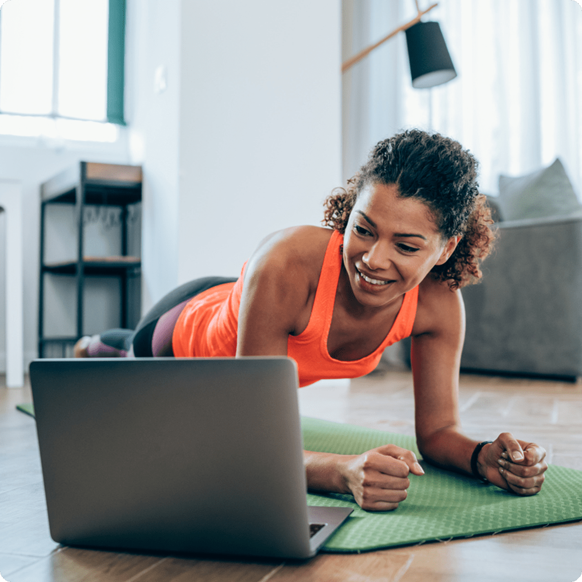 Woman streaming yoga at home with her laptop.