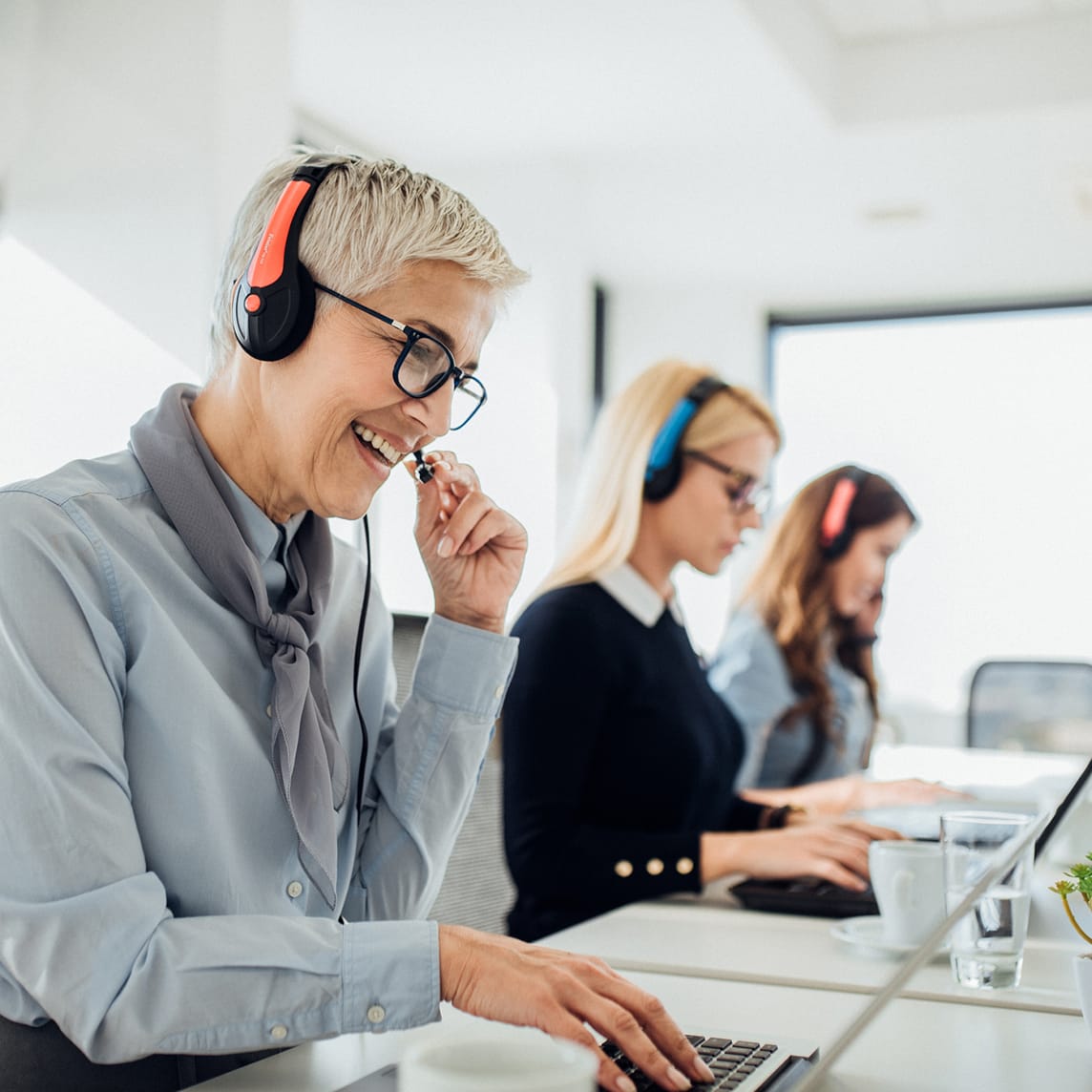 Three woman on the phone at call center