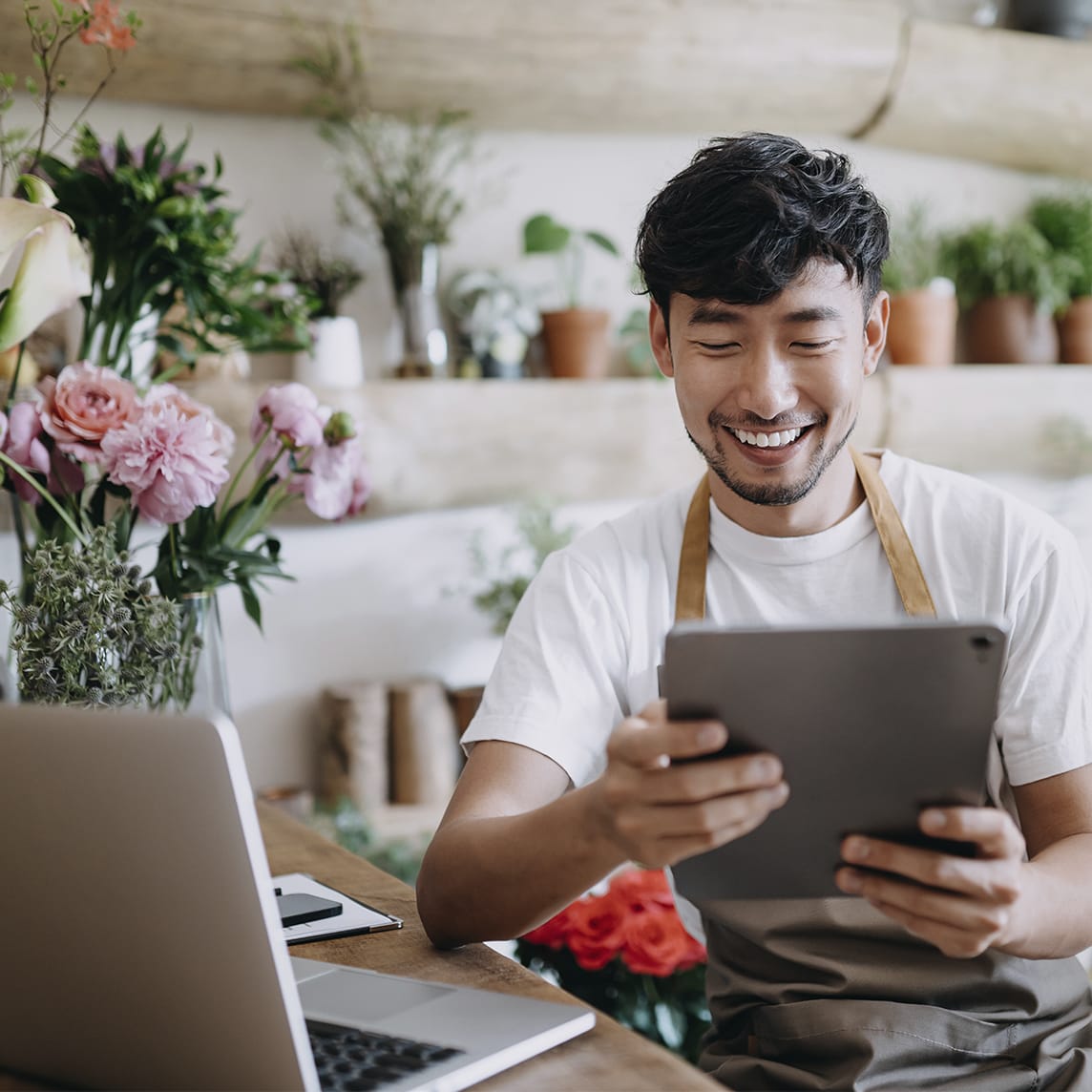 Floral shop owner working on tablet