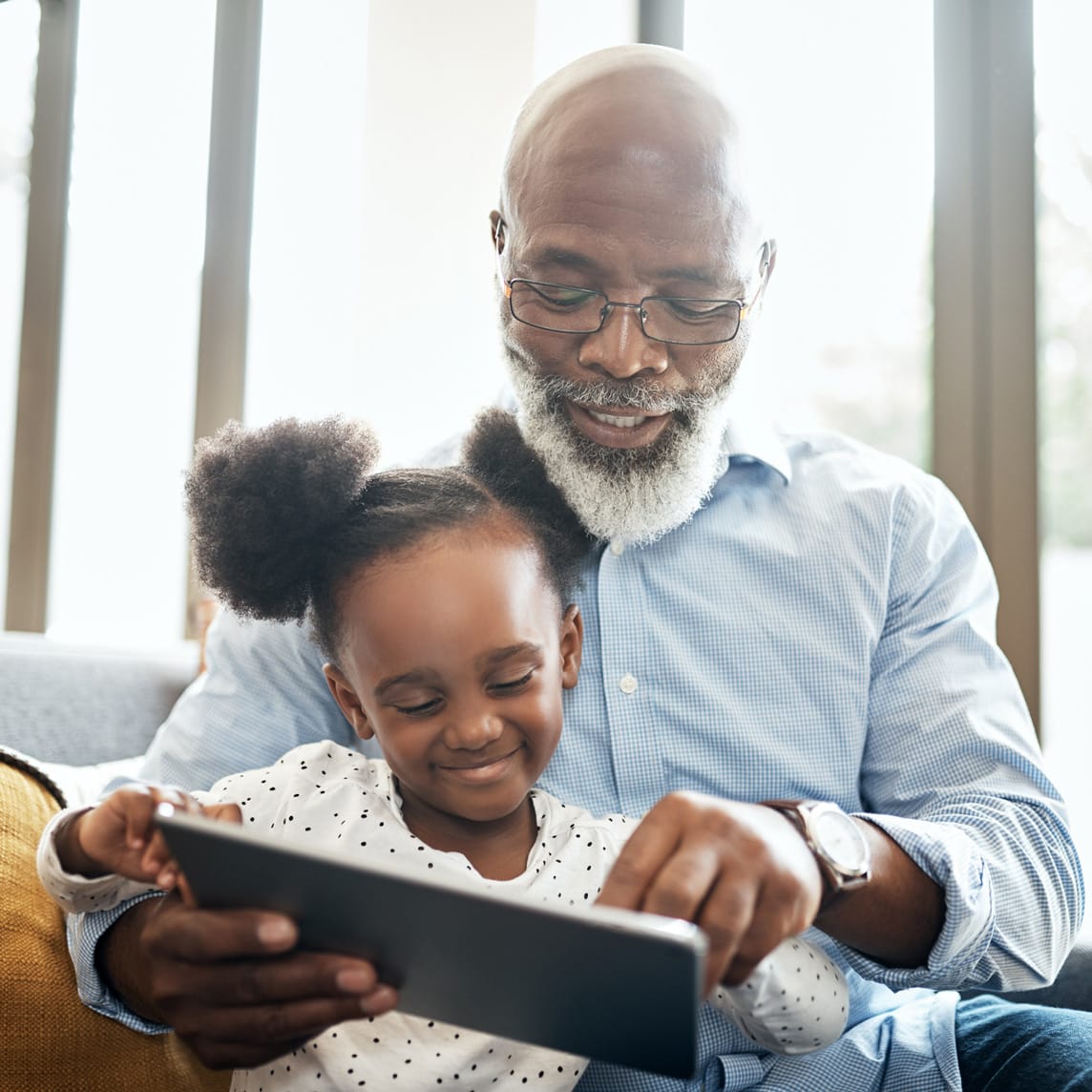 Grandfather and granddaughter on ipad