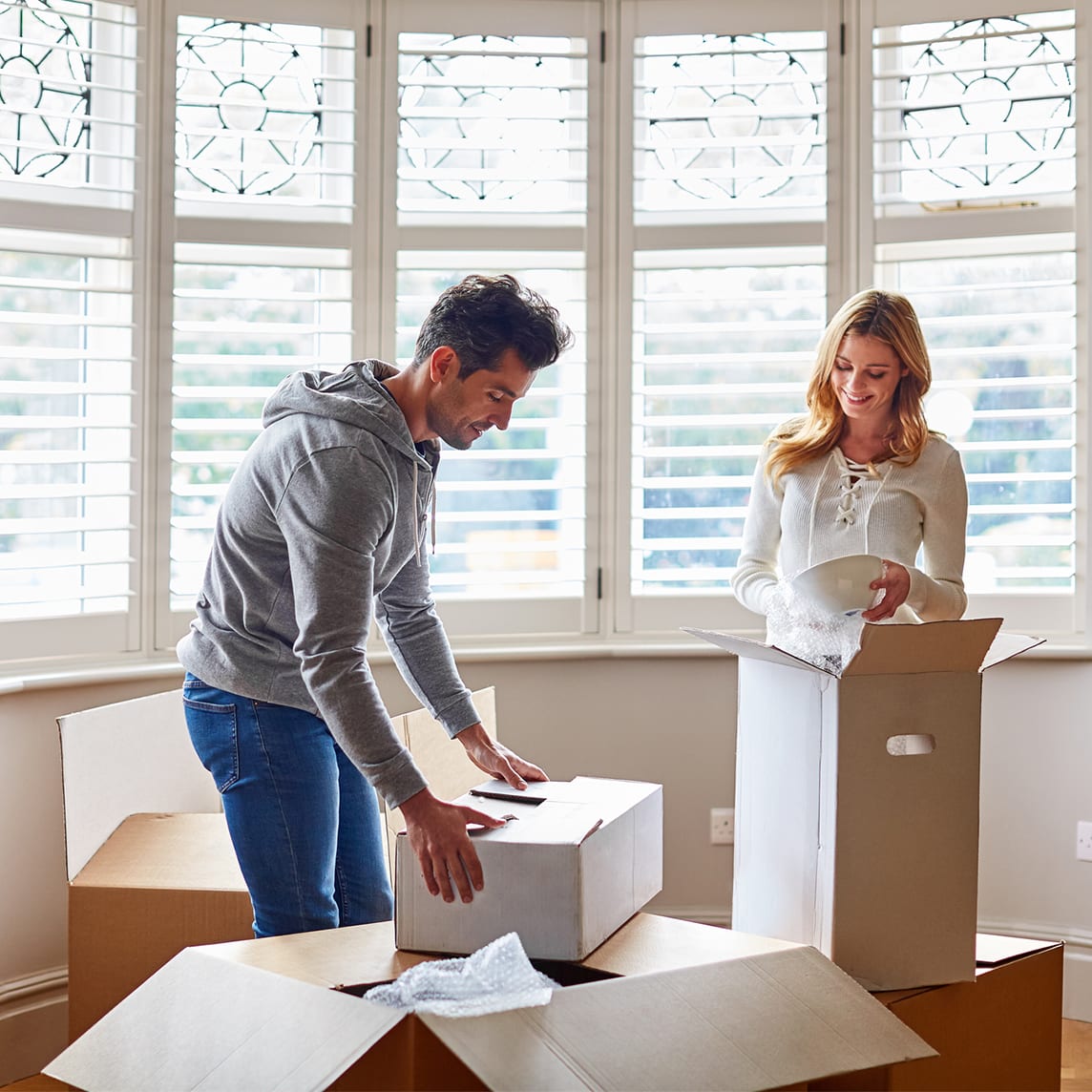 A couple opens moving boxes