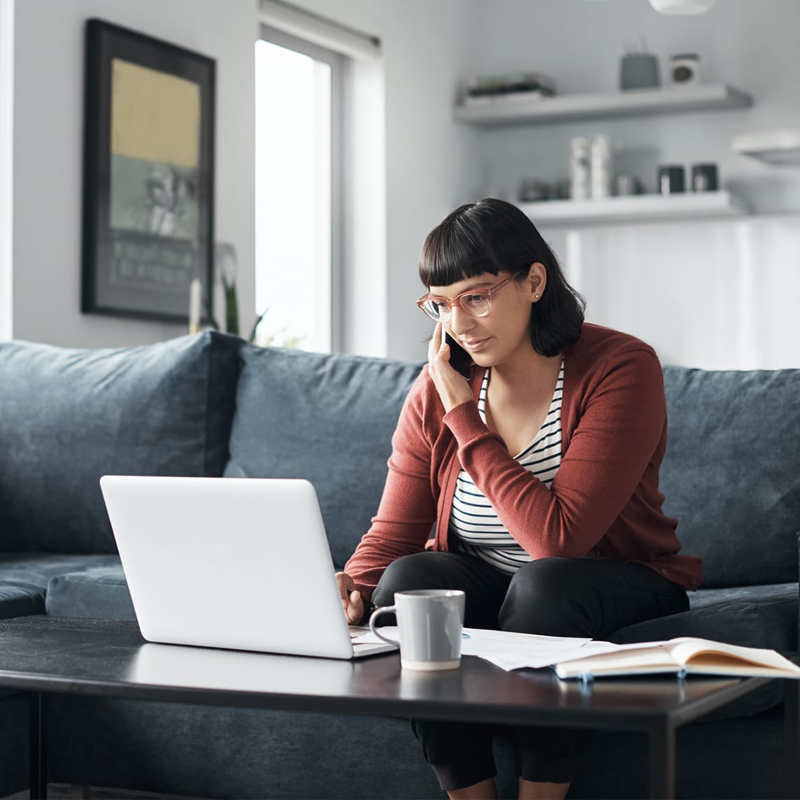 woman talking on phone while working at home