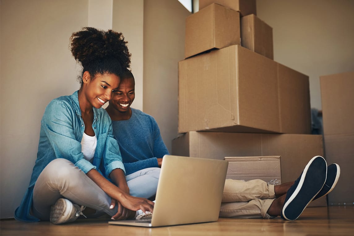 young couple with moving boxes