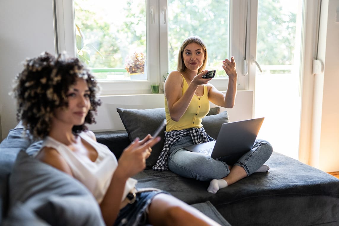 roommates watching tv and browsing the web