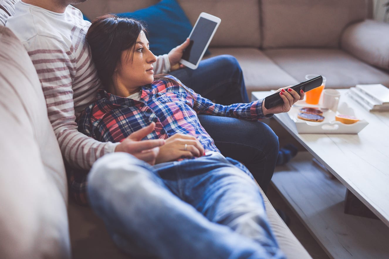 couple on couch watching tv