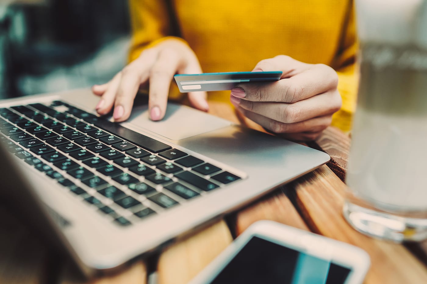 woman using credit card to make online purchase