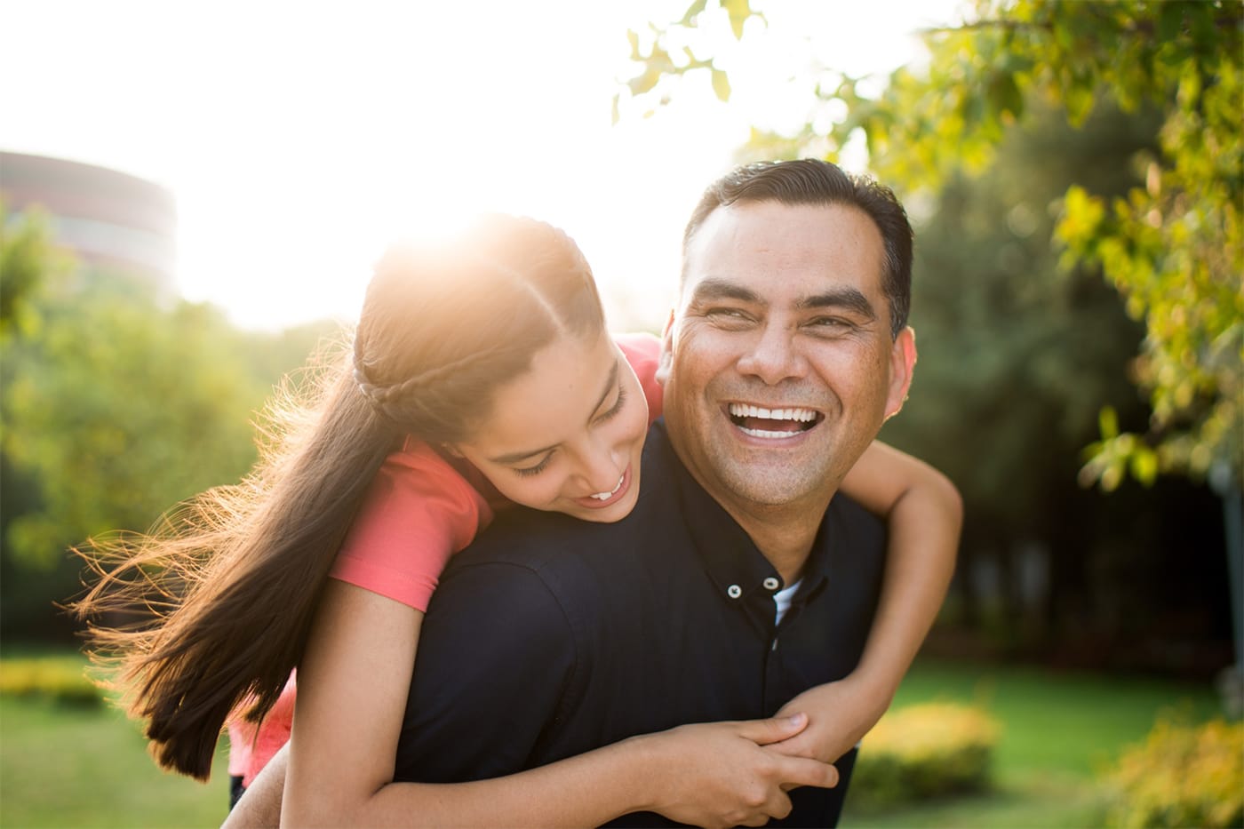 Father giving daughter piggyback