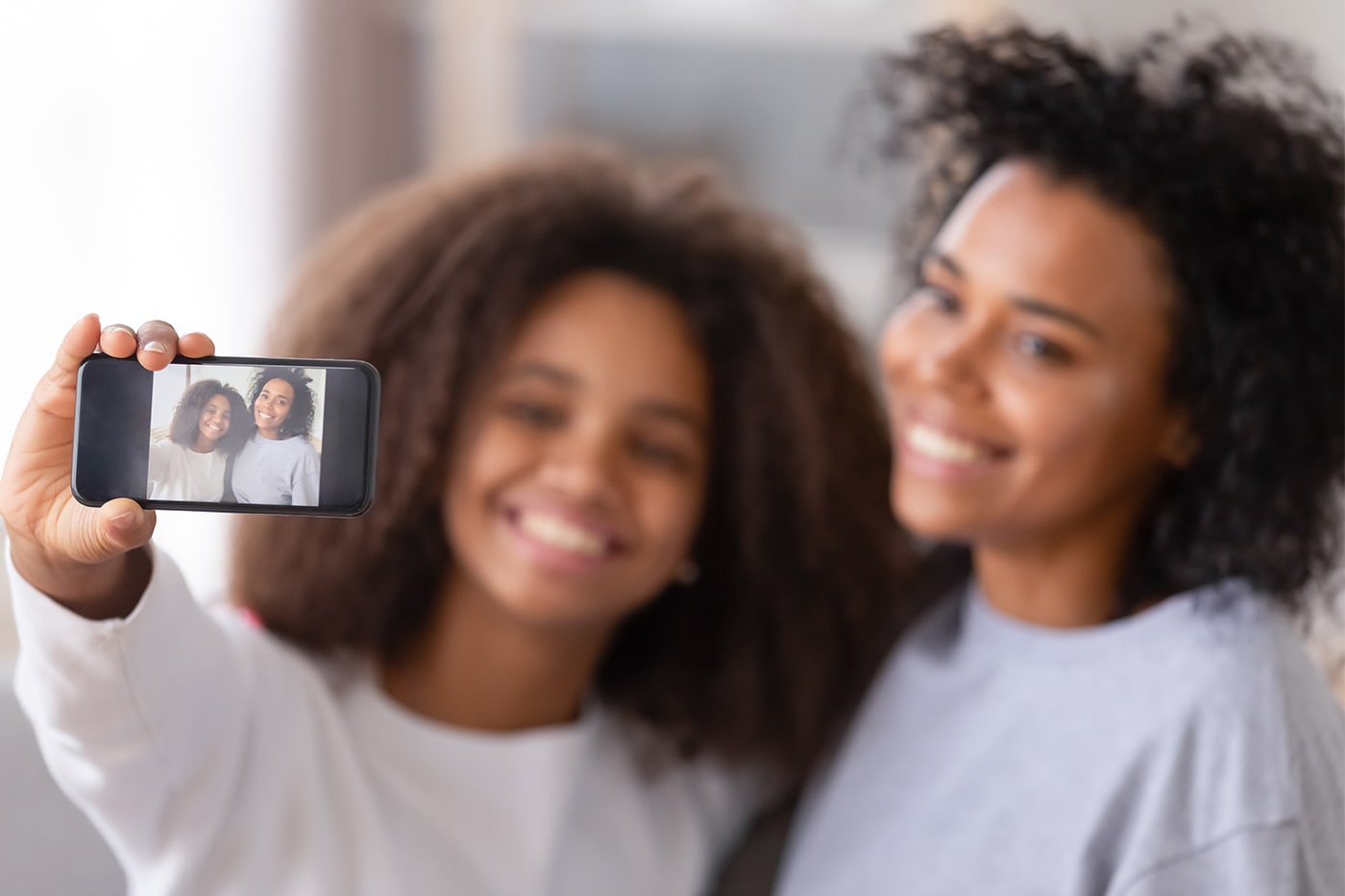 mom and daughter taking a selfie