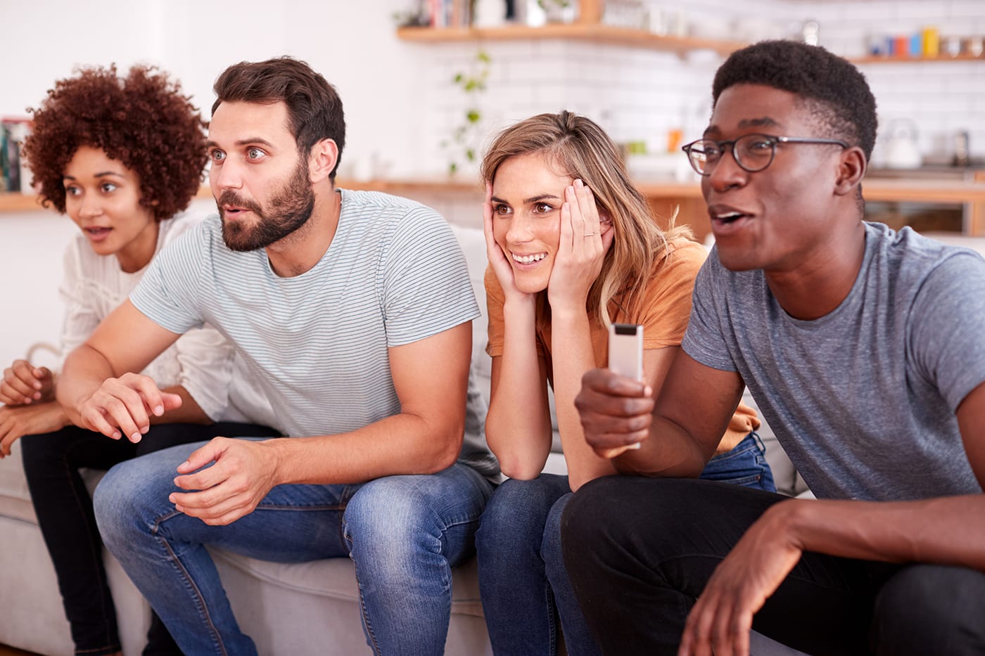 friends watching intense game on tv