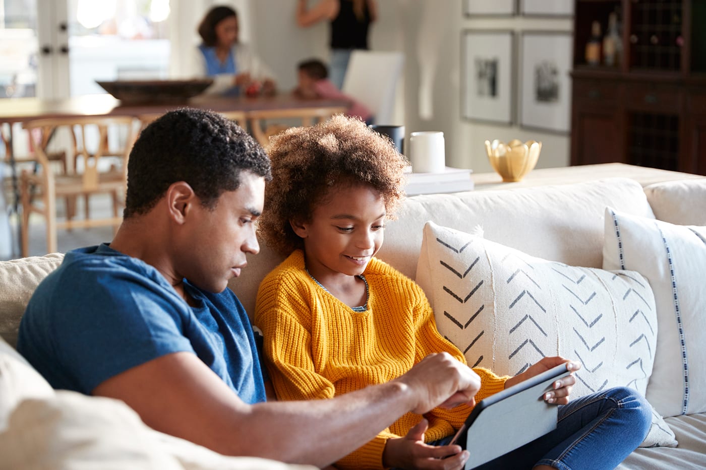 Father and daughter watching on tablet