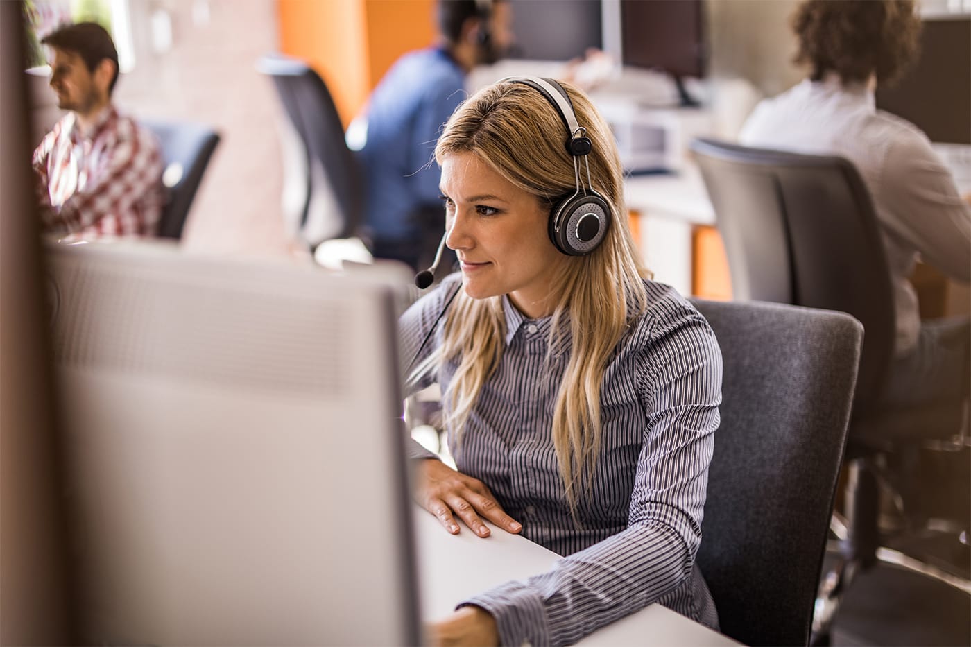 woman at computer with headset
