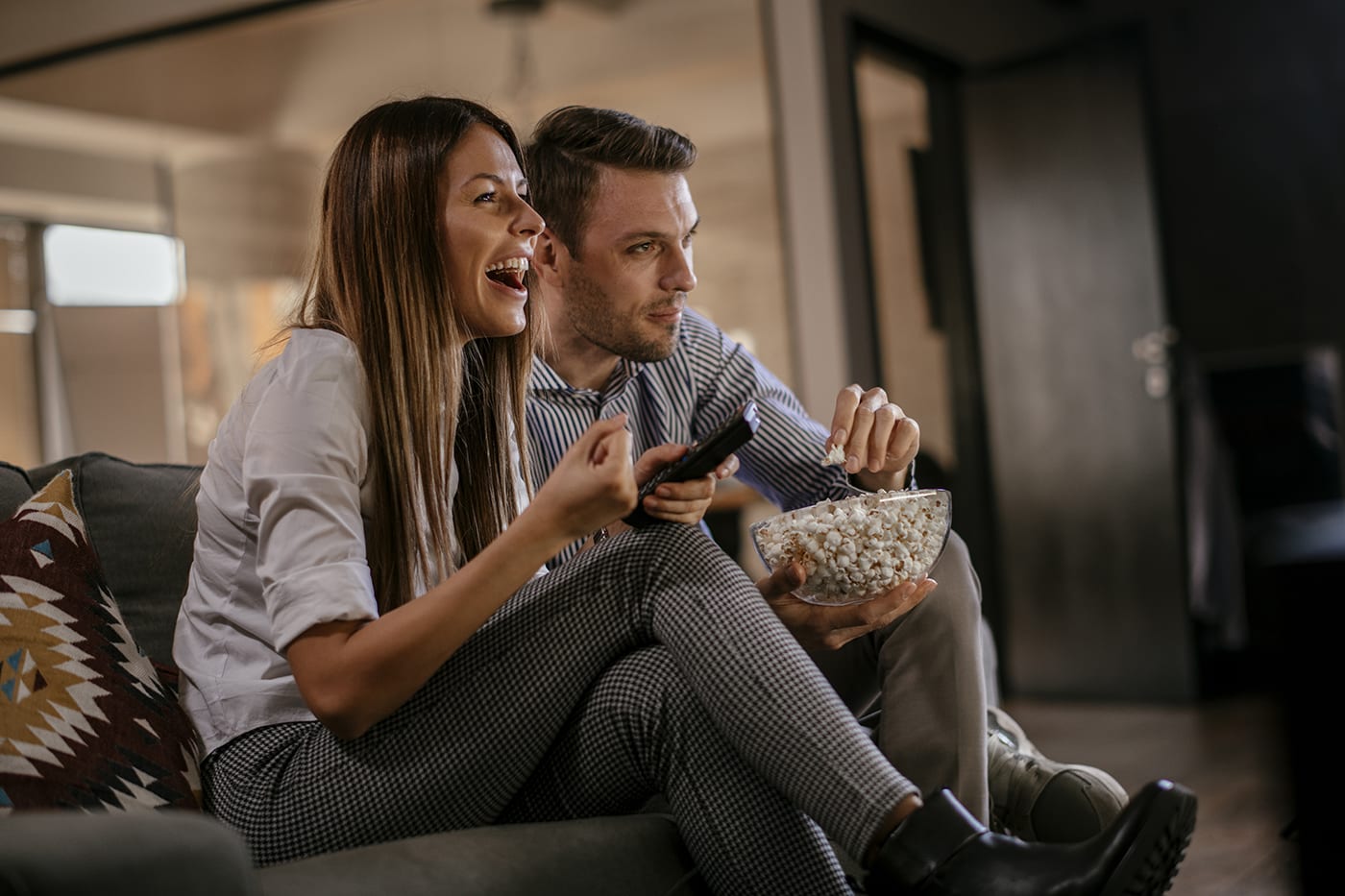 couple sitting on couch watching movie