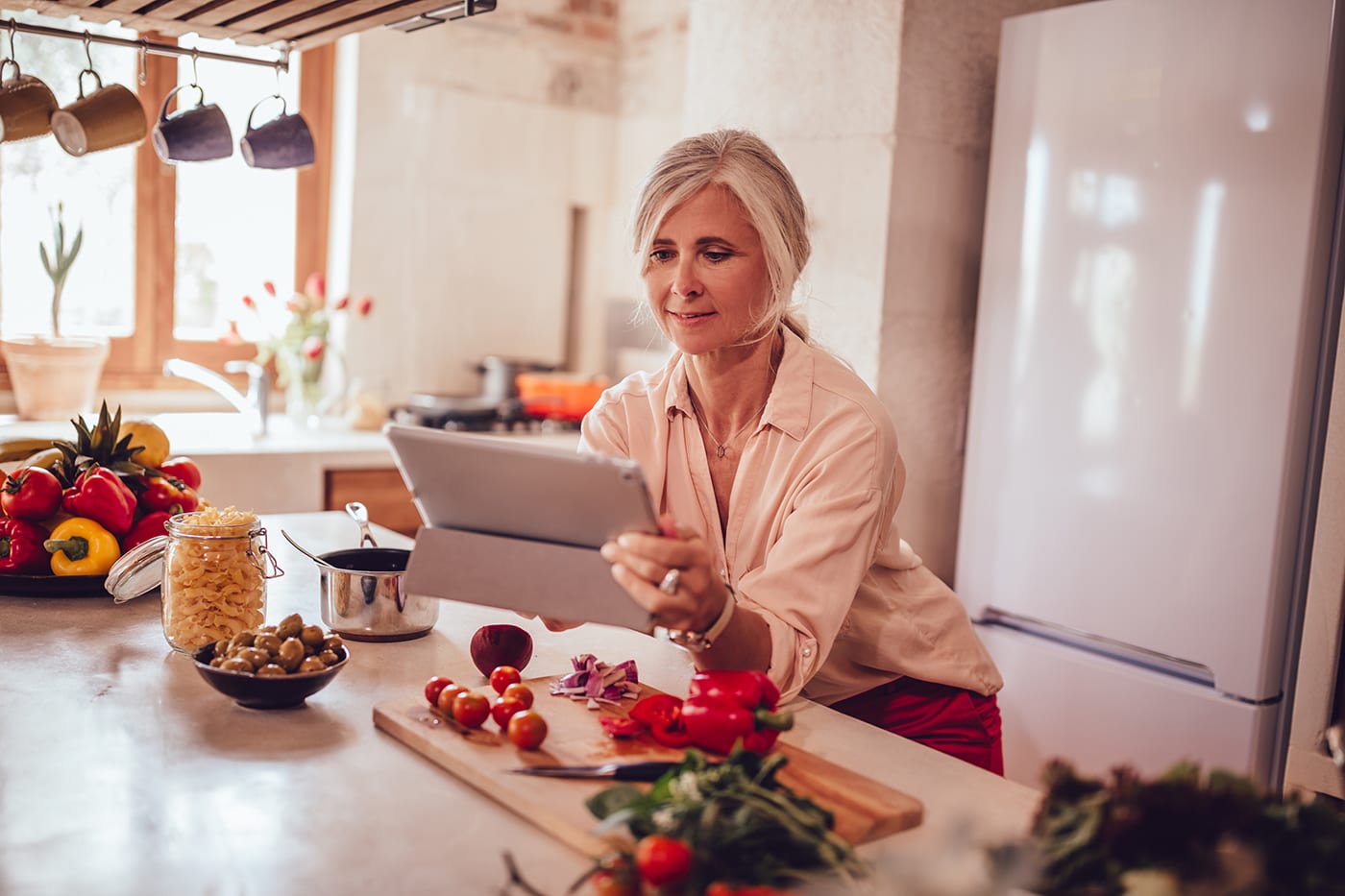 woman live streaming from kitchen while cooking