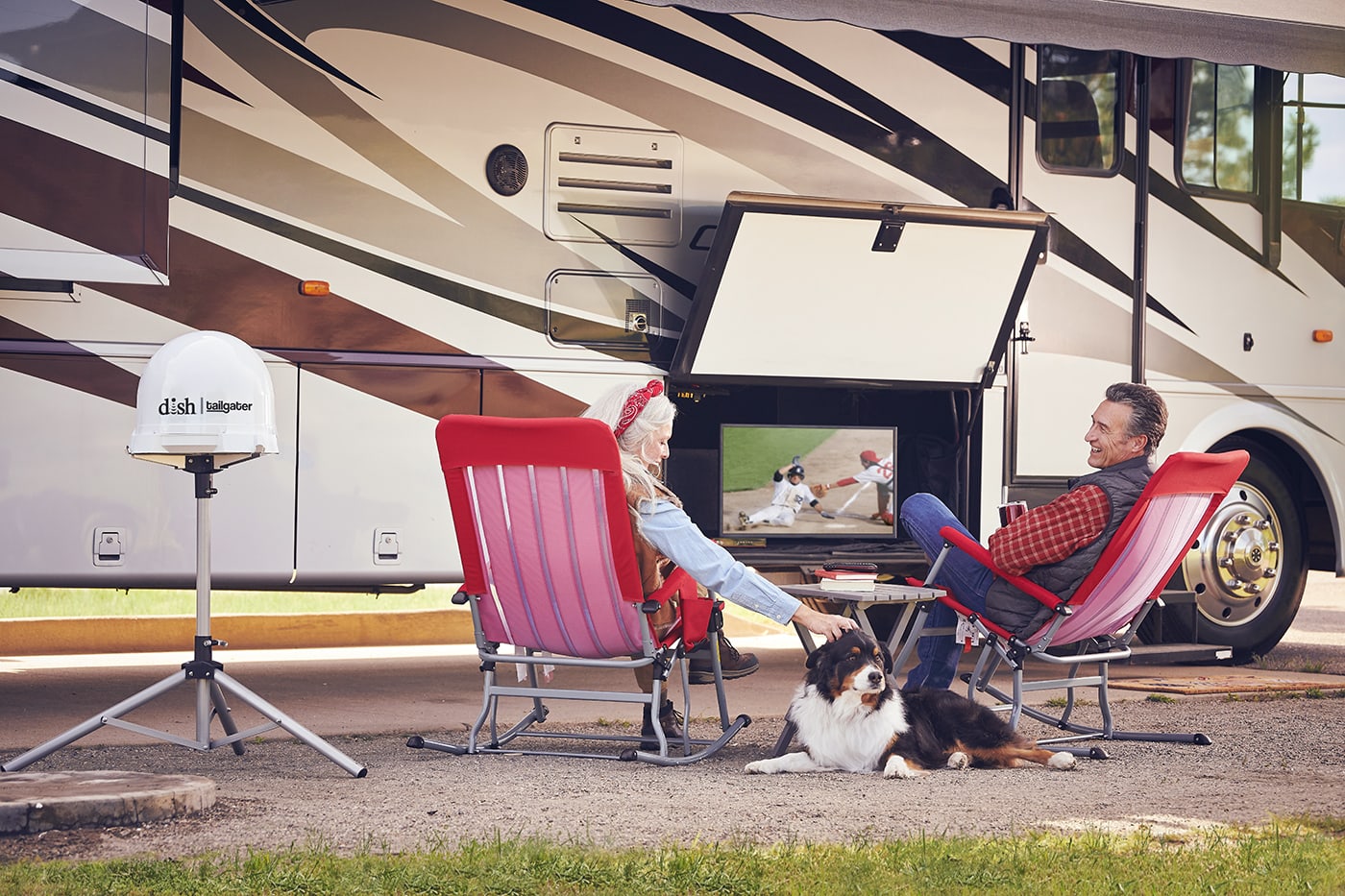 couple watching tv outside their RV