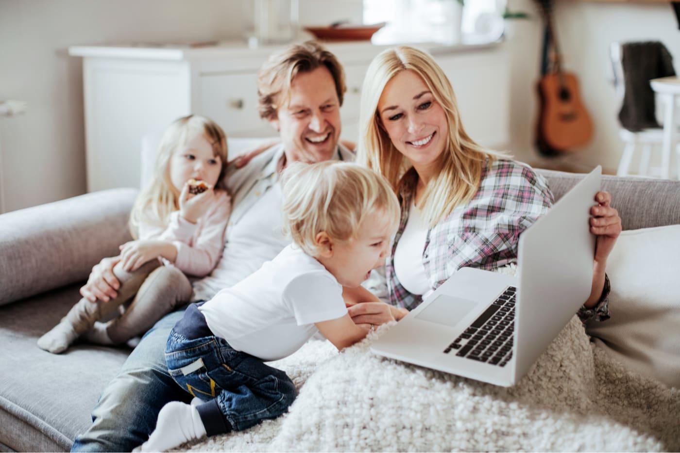 family on couch streaming laptop