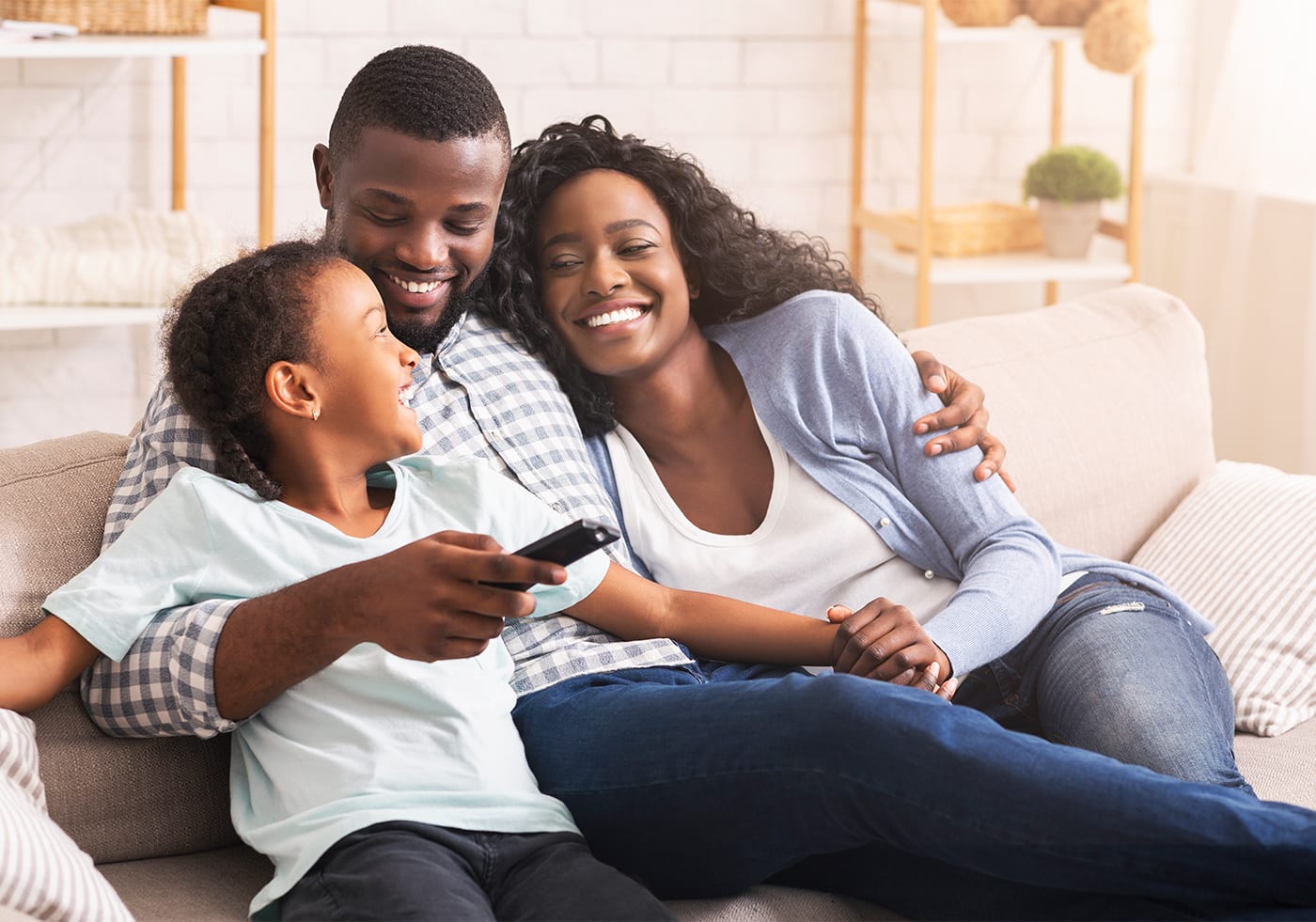 family laughing together on couch