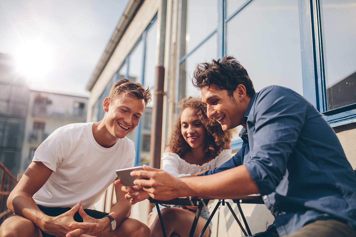 Group of friends watching tv on phone