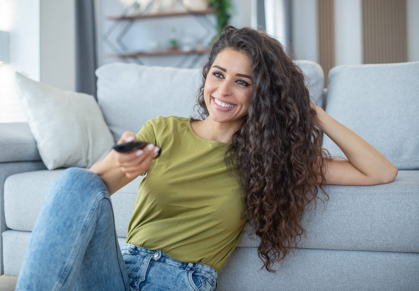 Woman watching TV in living room