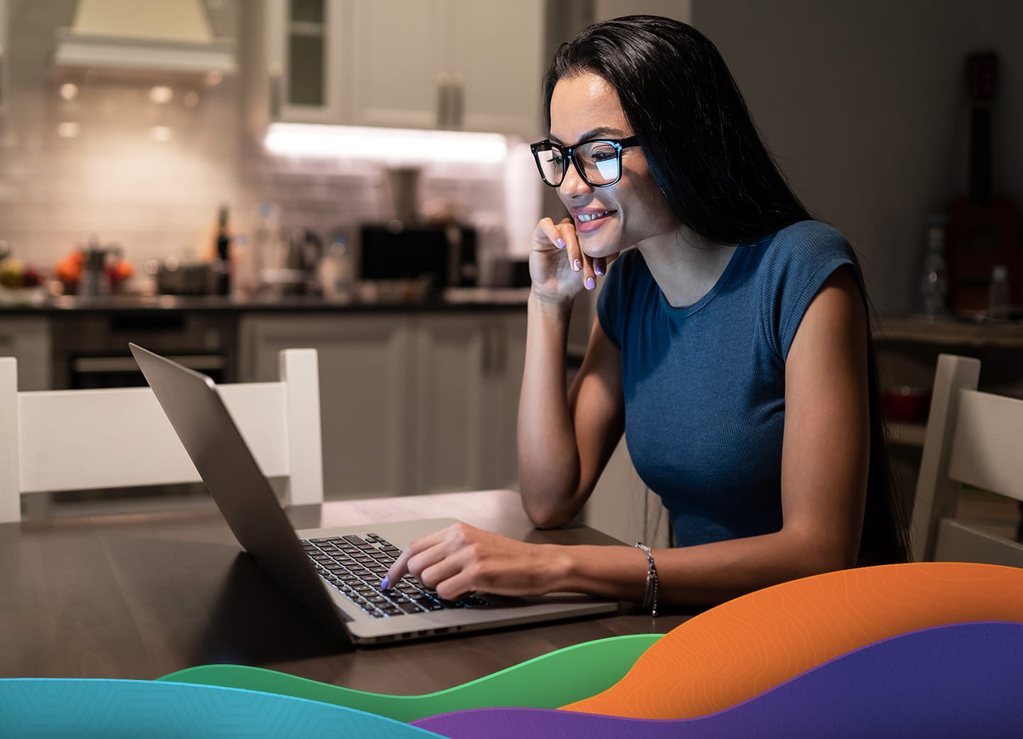 woman working on laptop on kitchen table