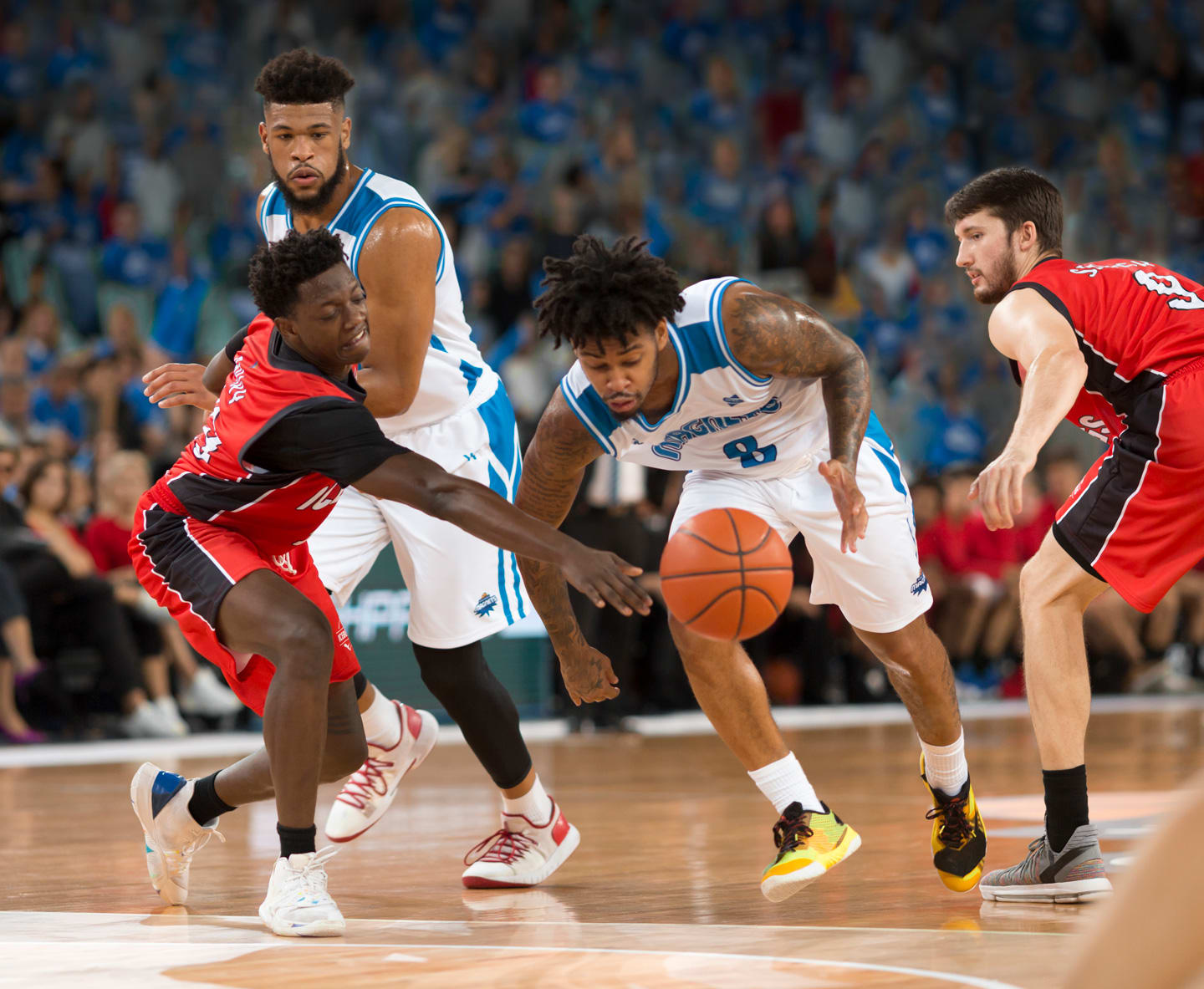 basketball player driving to the basket while guarded by an opponent