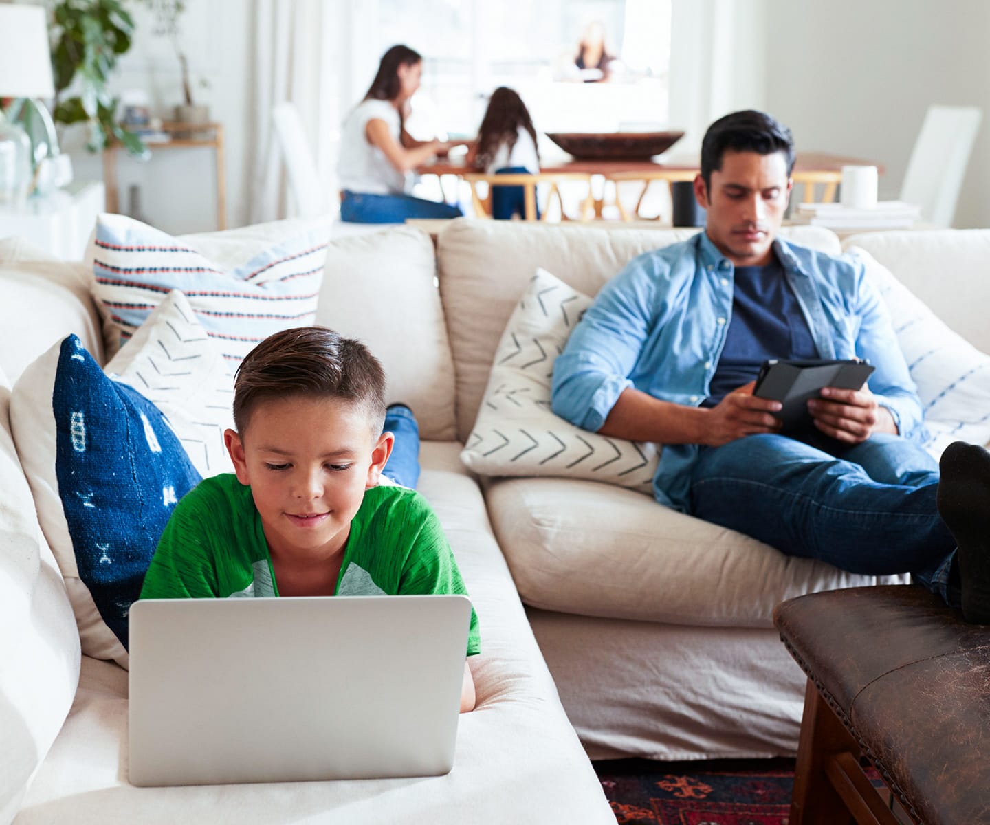 father and son using CenturyLink internet in their living room