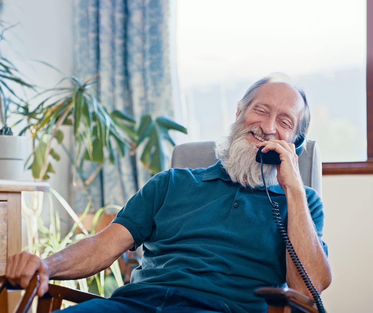 grandpa on a landline phone using CenturyLink home phone service