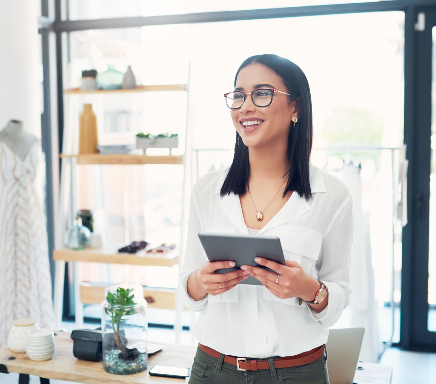 Female business owner holding tablet in store