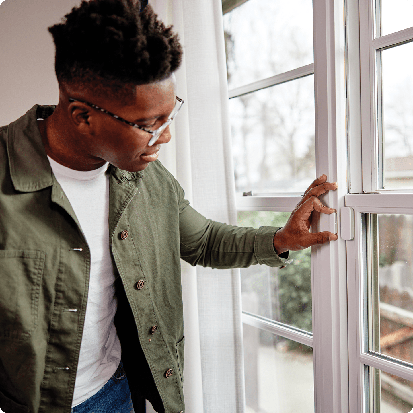 Man installing his Vivint window sensor