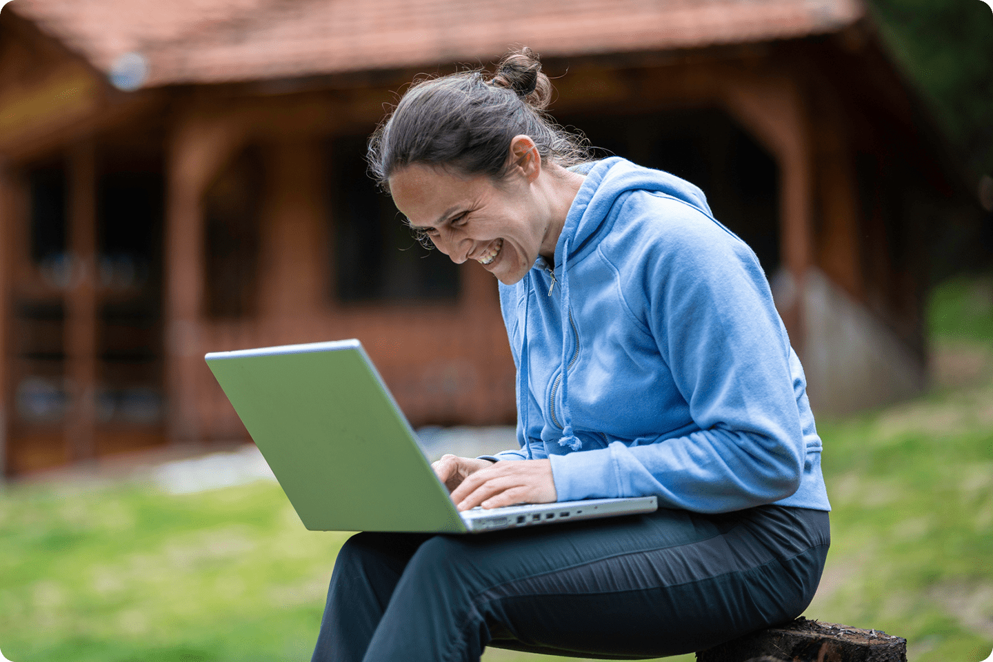 Woman uses fast internet outside in rural area.