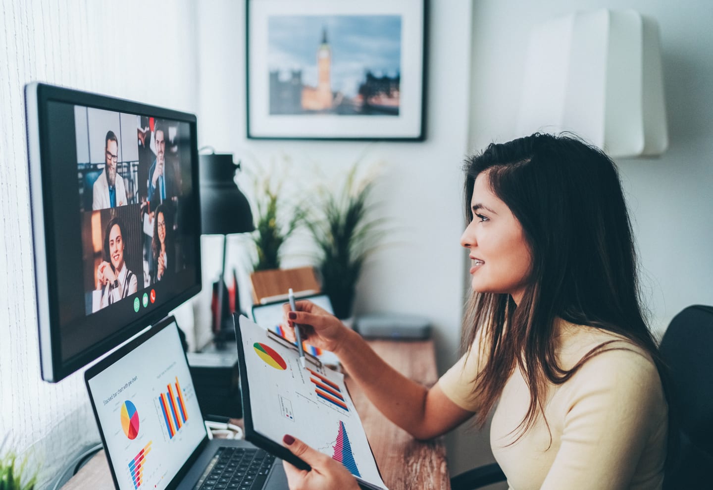 Woman using CenturyLink internet to participate in a conference call from her home office