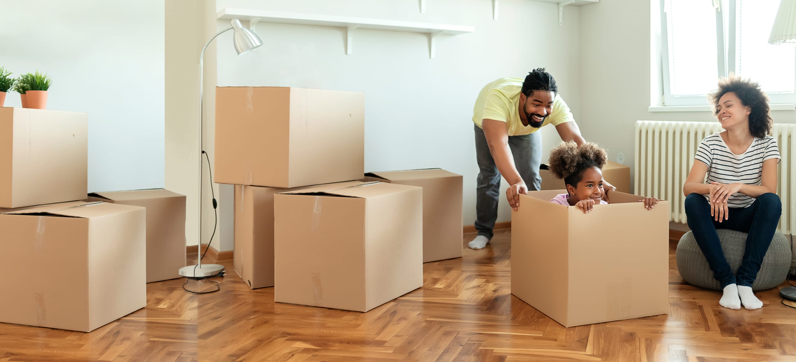 Family moving and playing in the boxes