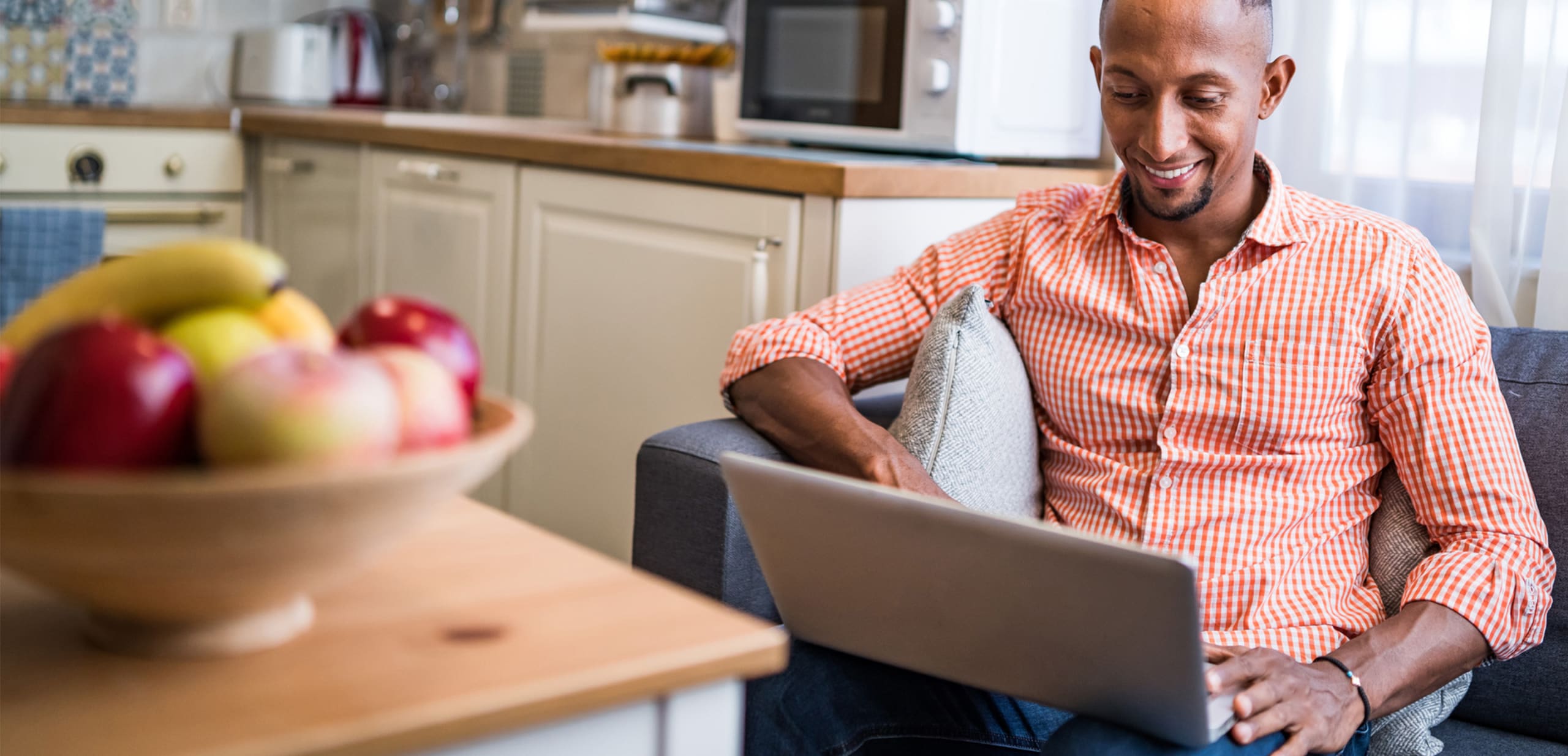 Latino man using laptop at home