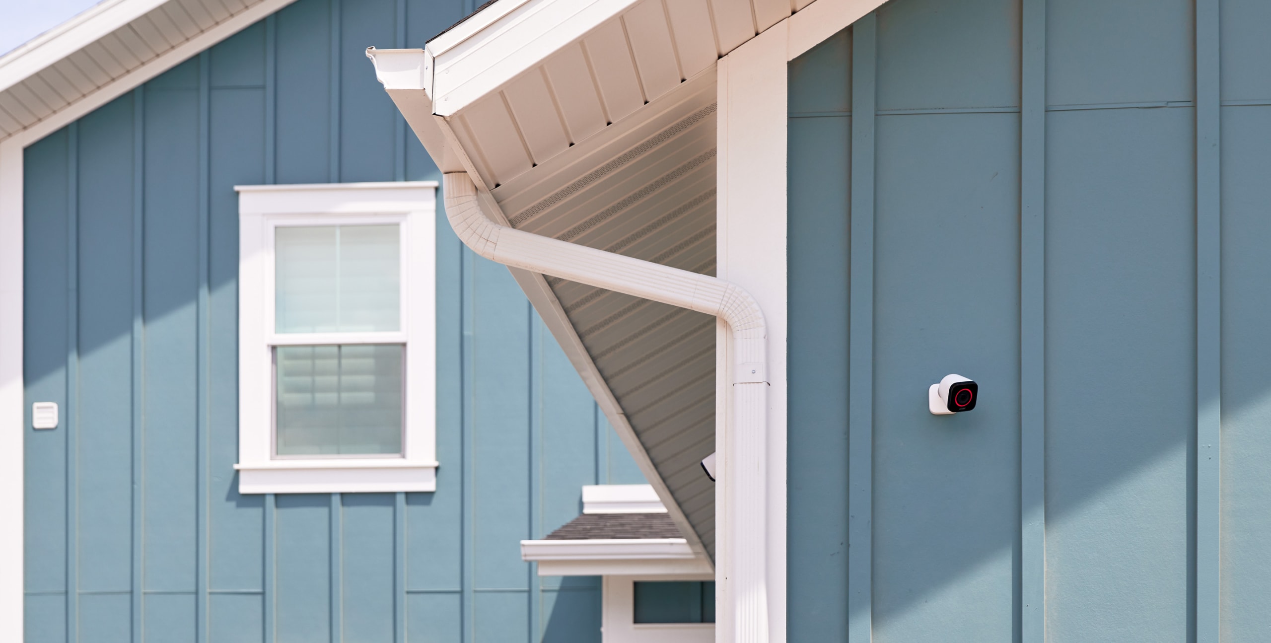 Vivint outdoor camera on a modern, blue house