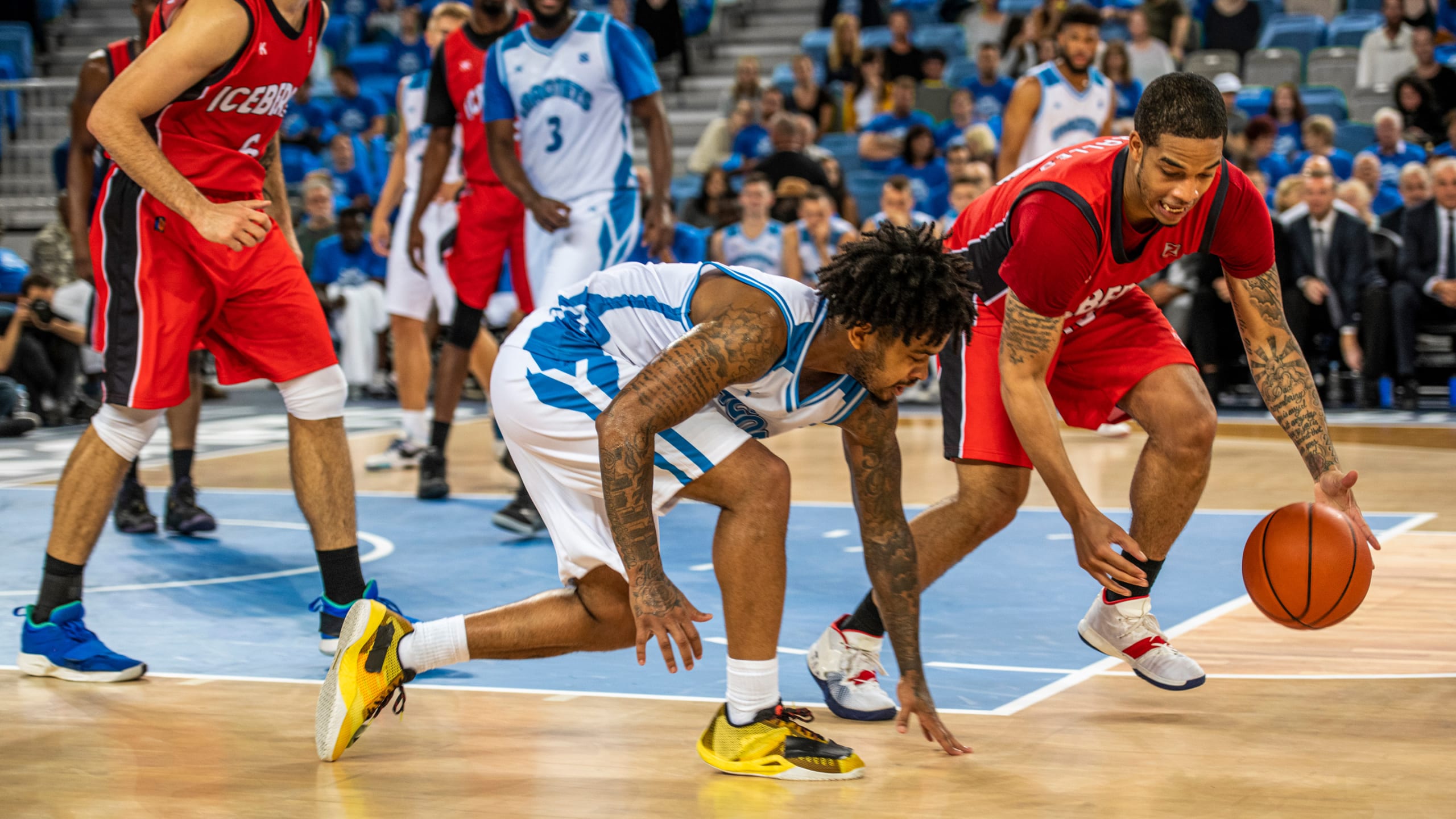 basketball players competing for possession of the ball