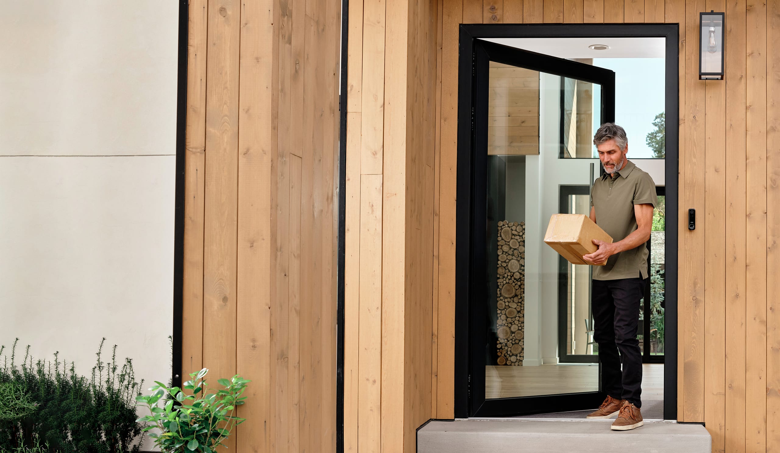 man picking up a package on his doorstep