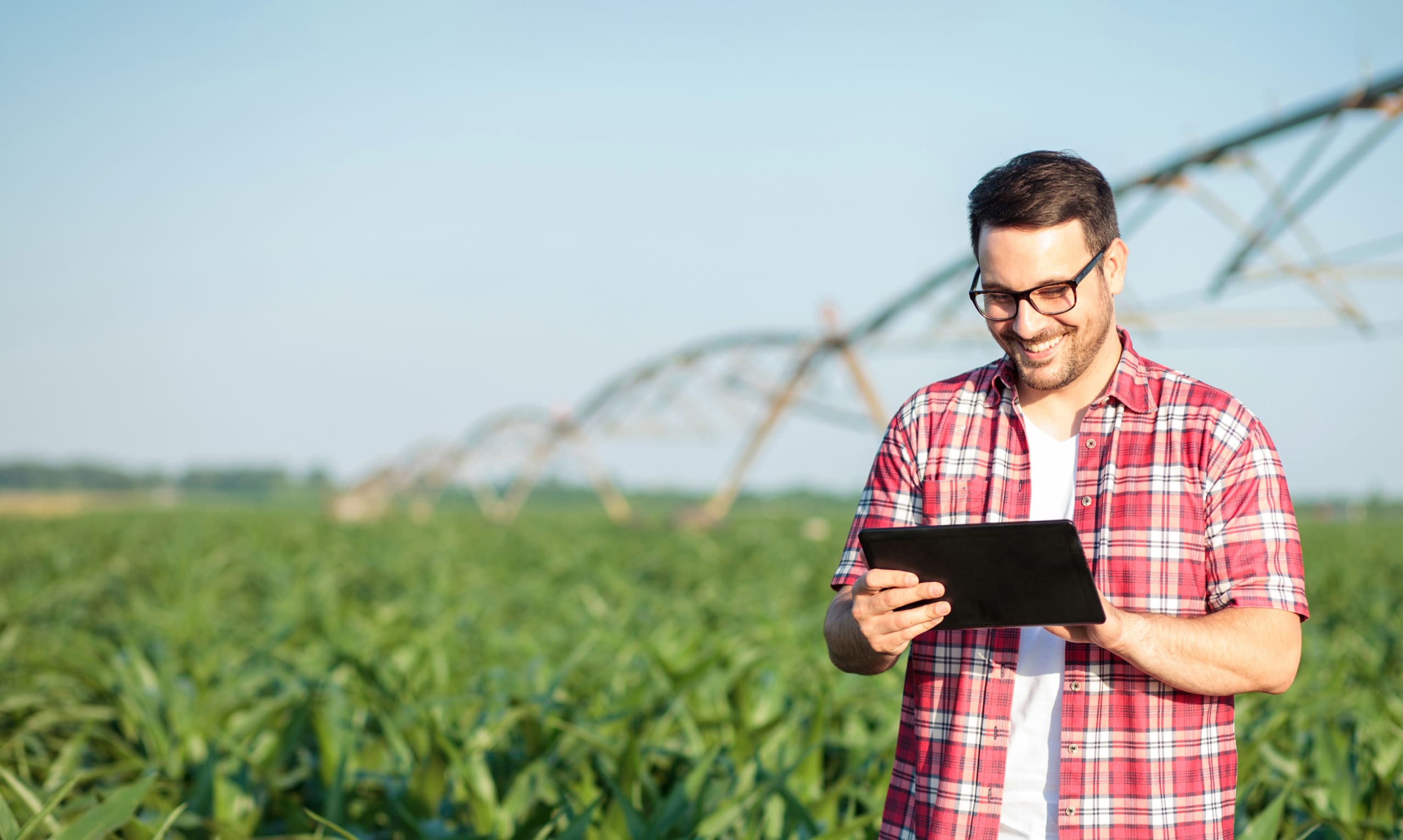 farmer on a tablet standing in a field