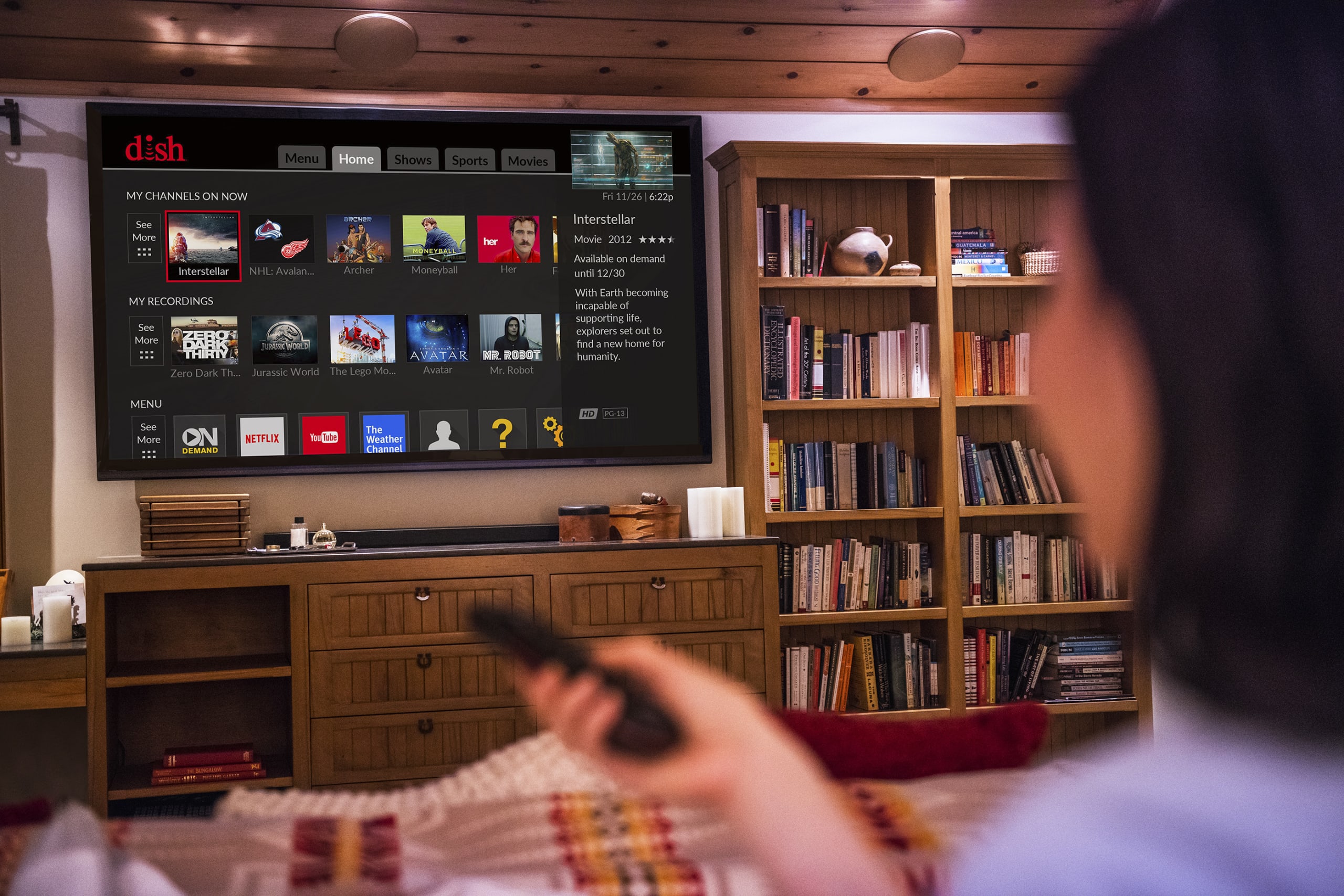 woman browsing media content on TV