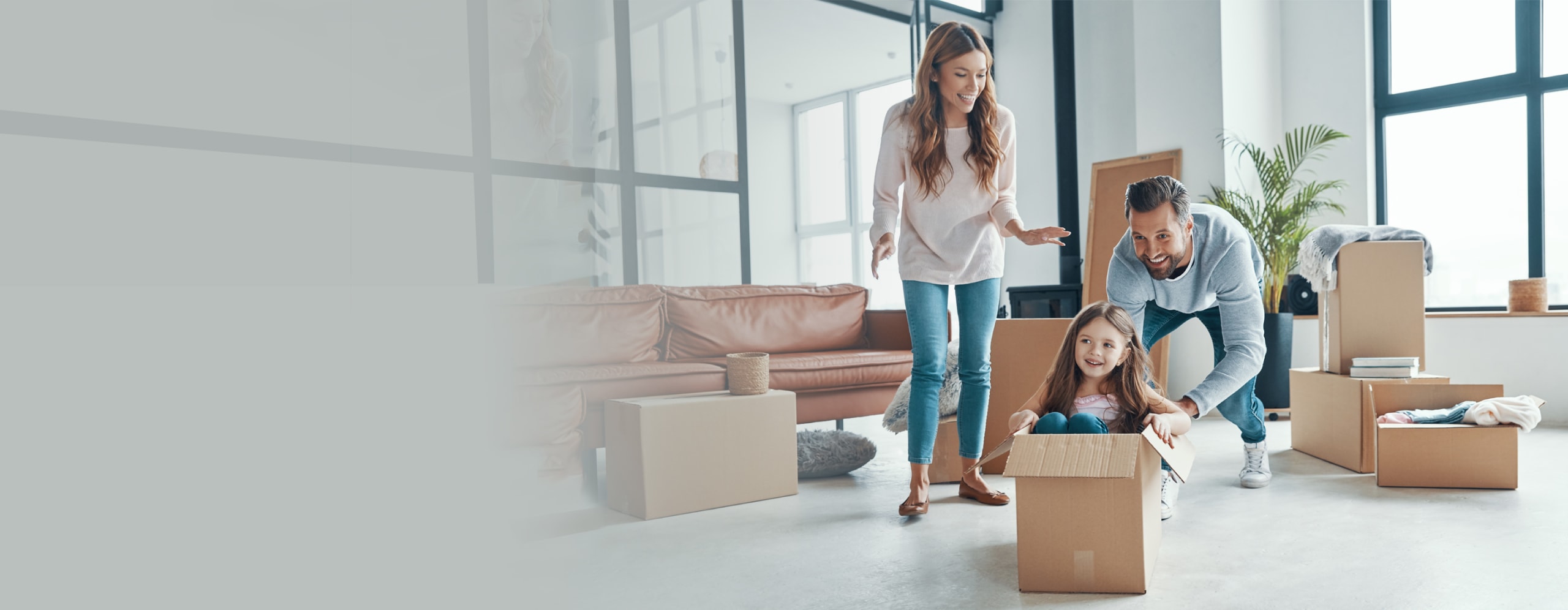 Parents pushing kid around in moving box